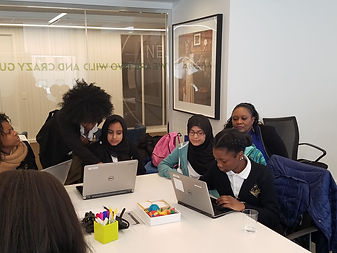 Students working on laptops at a Girls Tech Conference