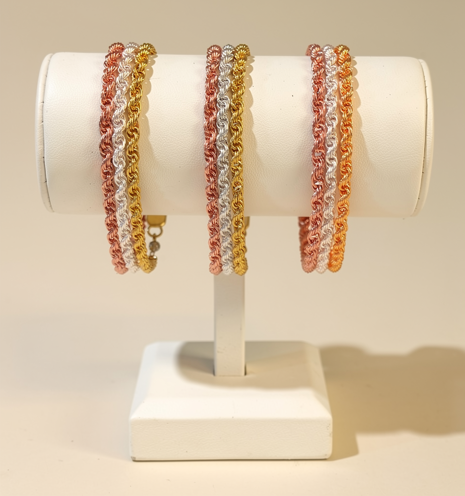 Three Triple Spiral Weave bracelets handcrafted in silver, gold and rose gold rings woven into a spiral pattern.