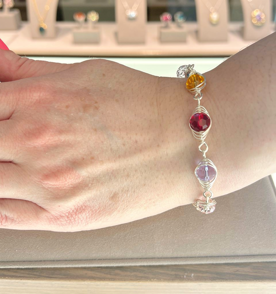 Women wearing the silver Herringbone Link Birthstone Bracelet  featuring Austrian crystal birthstones from WildGeraniumJewelr