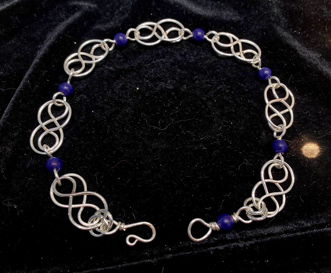 Silver bracelet of Celtic wire pattern with cobalt blue crystals from WildGeraniumJewelry/com