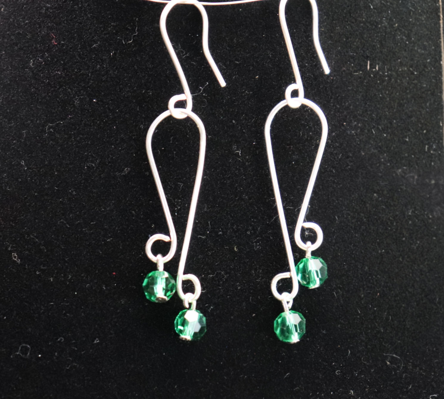 Double drop earrings with emerald green crystals dangling from silver wire from WildGeraniumJewelry.com.