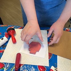 A guest test-stamping their block on paper