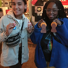 2 Guests holding their completed earrings