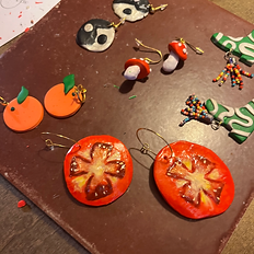 A tray of handmade clay pieces by workshop attendees