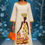 Miniature : Femme en robe longue, imprimé d'une Africaine, tenant un sac orange. CiaacCulture.net