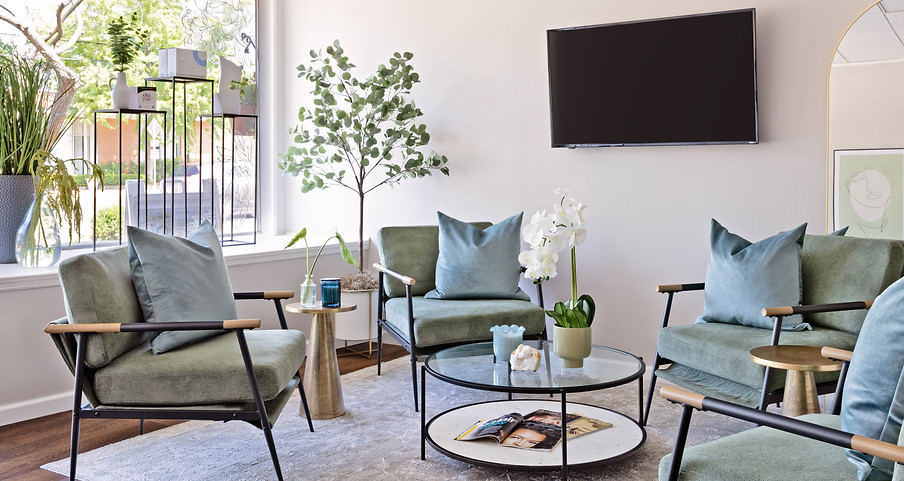 Cozy waiting area with plush seating, soothing artwork, and neutral decor in the Skincare Studio