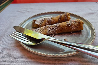 Authentic European Nutella crepe served on a plate with cutlery.