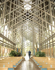bride and groom at the altar in thorncrown chapel hot springs photographer wedding photographer