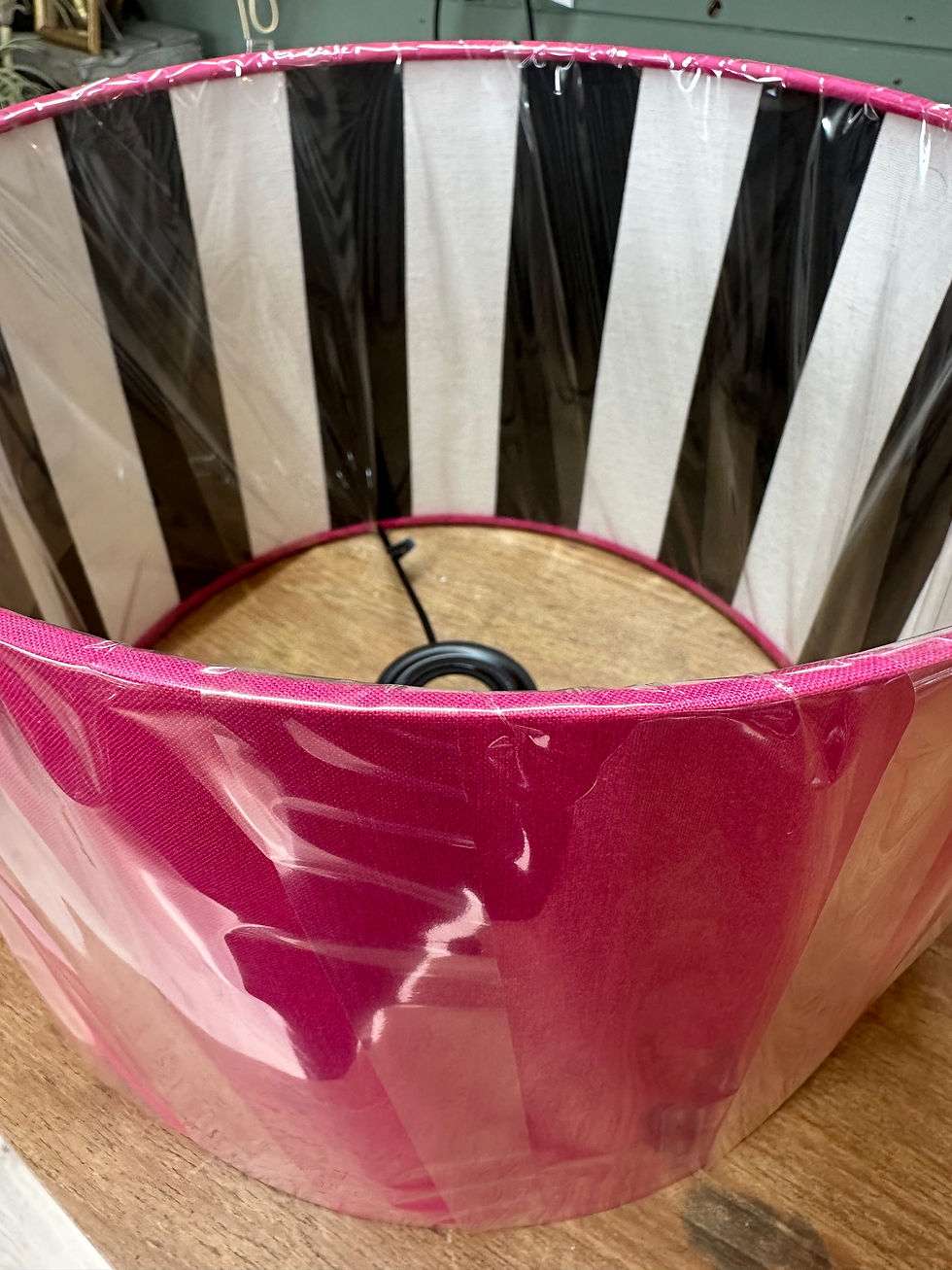 fuchsia pink handmade lampshade with black and white stripe inner