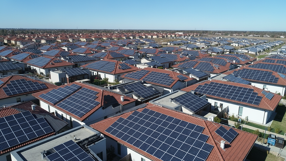 High angle view of a solar panel array on a rooftop under clear blue sky