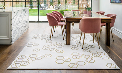 dining room in large naturally lit room with feature rug styled by Stylist, Lucy Gough