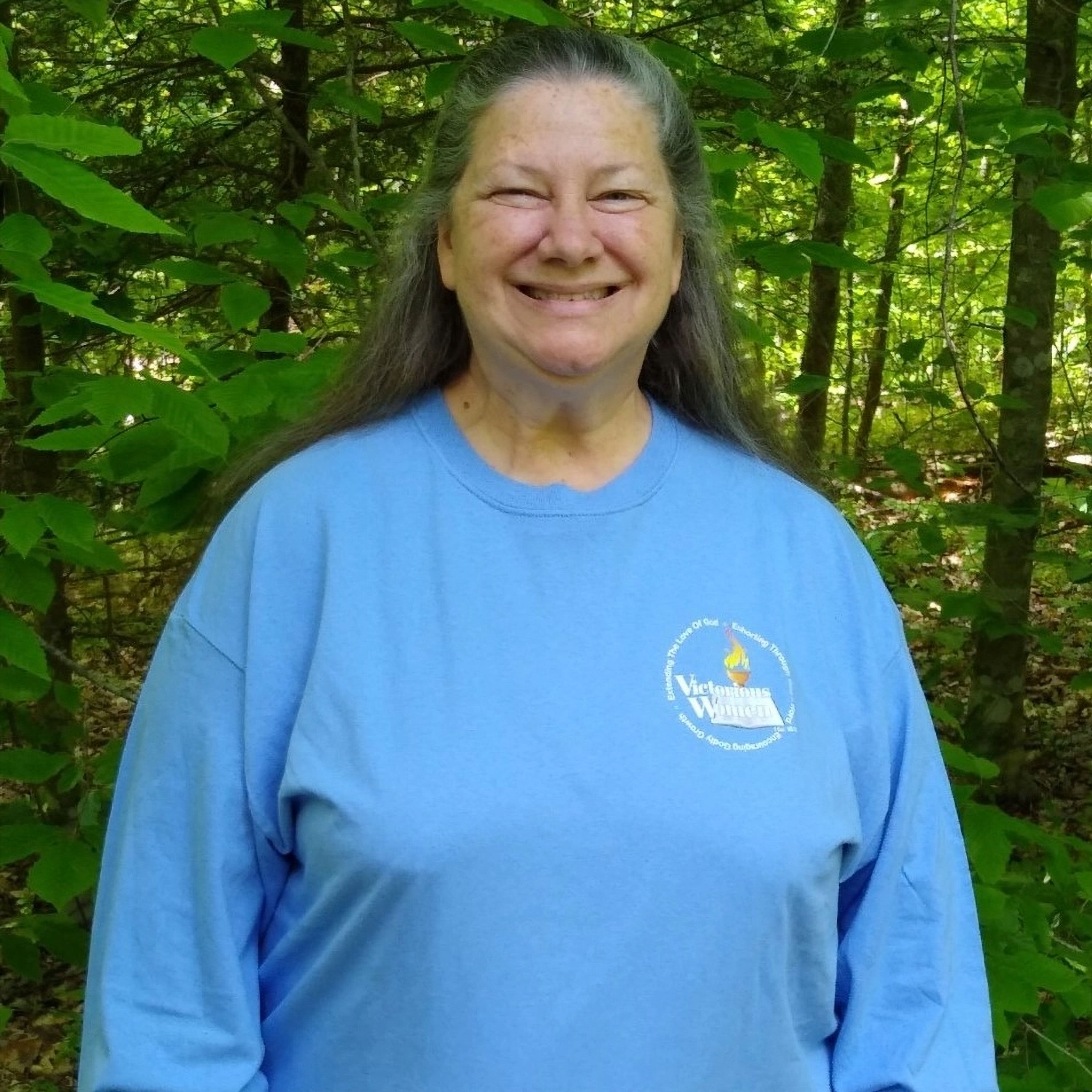 Smiling woman in light blue sweatshirt