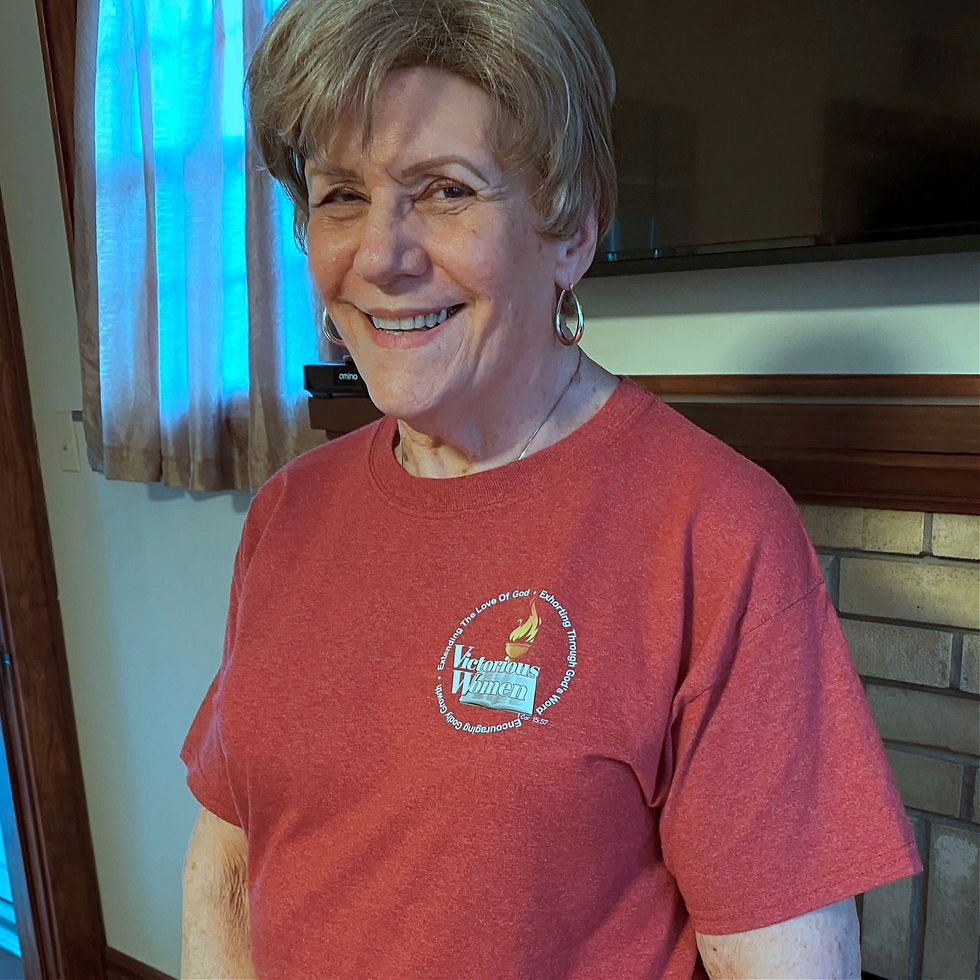 Thumbnail: Smiling woman wearing red Victorious Women Inc shirt