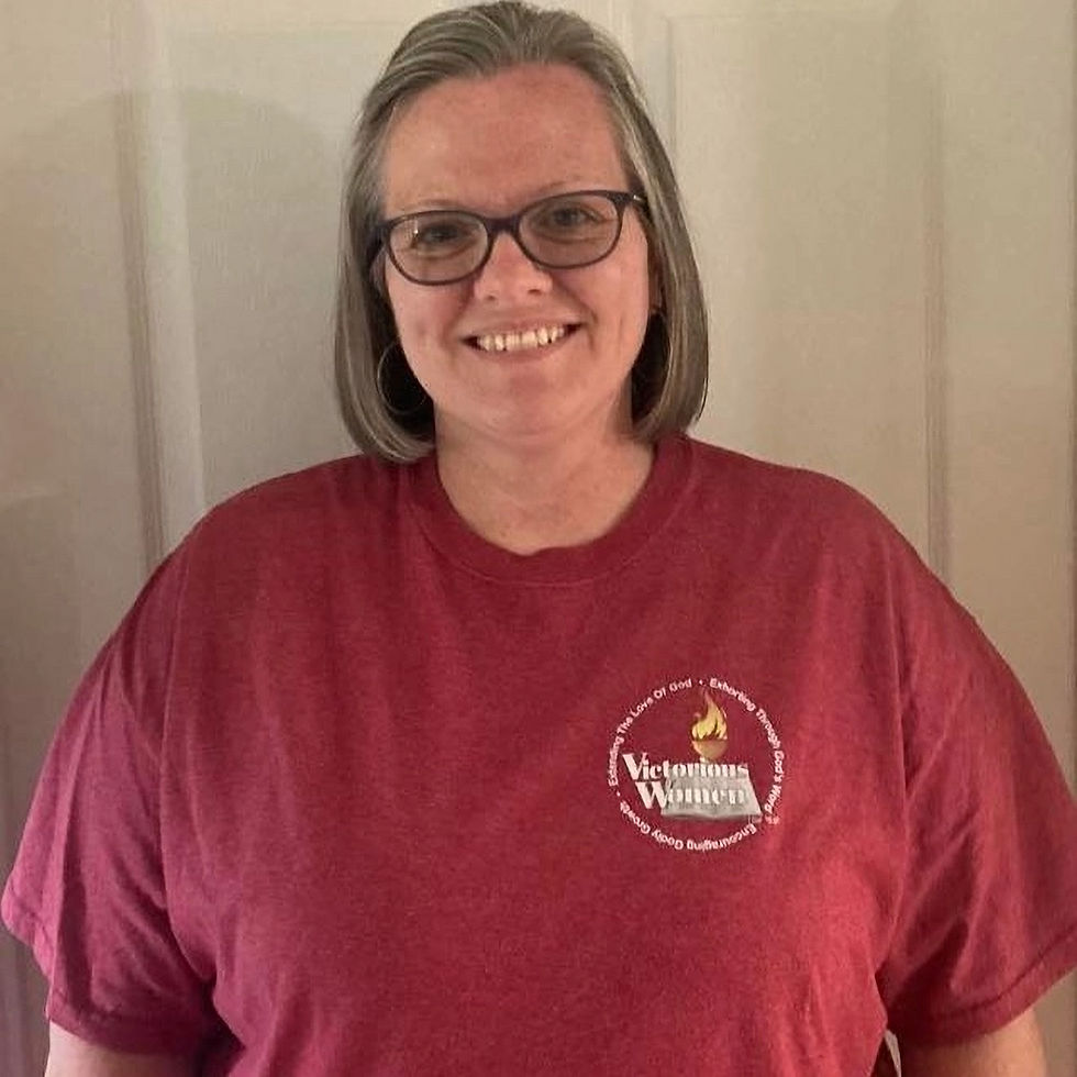 Thumbnail: Smiling woman wearing Victorious Women Inc. t-shirt