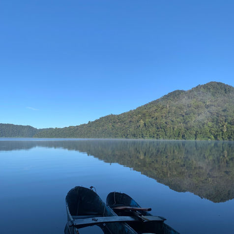 Two boats on serene lake reflecting mountains