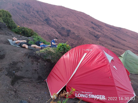 Hikers resting near red LongSinger tent