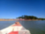 Canoe crossing Caraiva river heading towards a beach