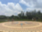 People stand on the large tiled sundial and compass, Rosa dos Ventos, which sits in front of the lake at Ibirapuera park