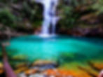 A waterfall drops into a bright turquoise pool below at Santa Babara waterfall