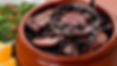 Bowl of feijoada in a brown pot