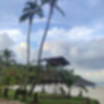 A small wooden lifeguard hut stands behind the white sand of Costa Beach, Itacare