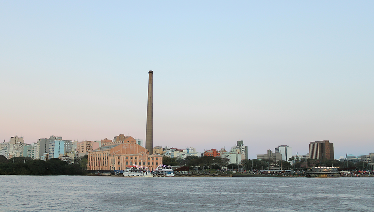 View back to the port and a tall tower from out on the river, in Porto Alegre