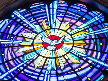 Stained glaas window with a dove representing the Holy Spirit