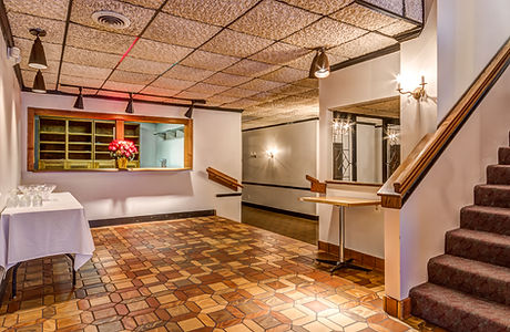 Orchard Lane’s welcoming entrance hall and staircase connecting the venue’s indoor levels.
