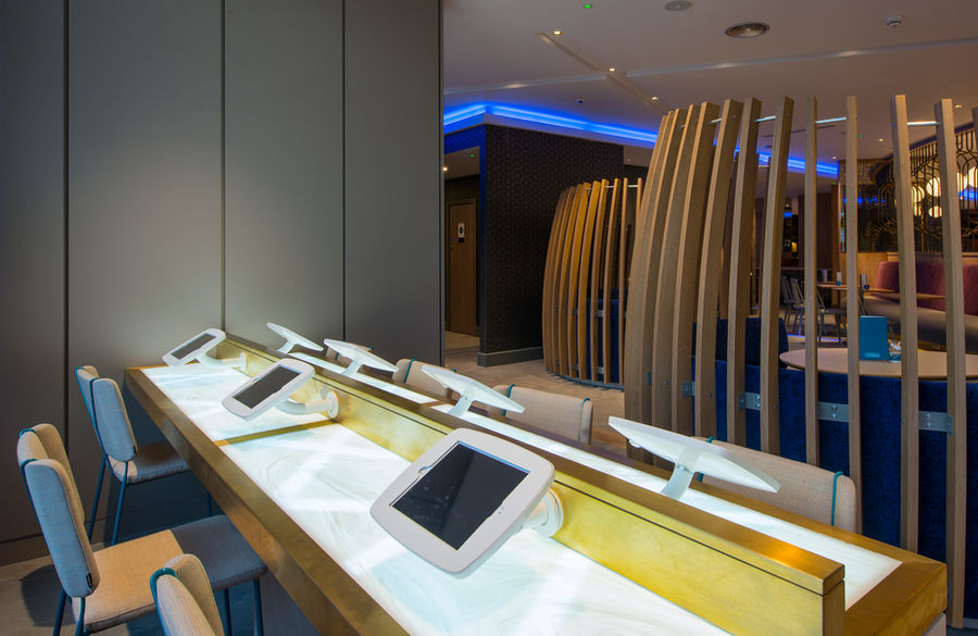 Custom desks and wall panelling for Novotel London, manufactured and installed by Forest Contracts.
