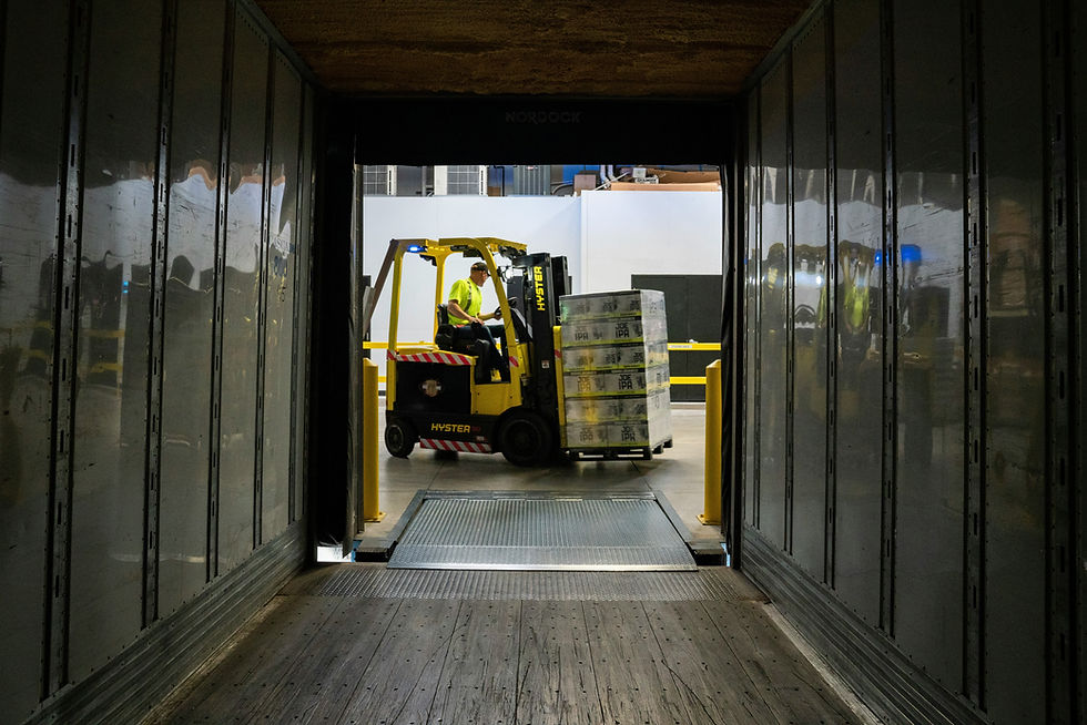 Fork Lift entering trailer by way of dock leveler
