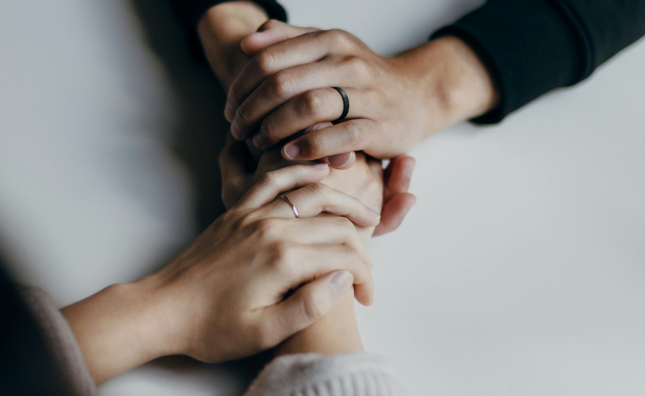 People holding hands to show support.