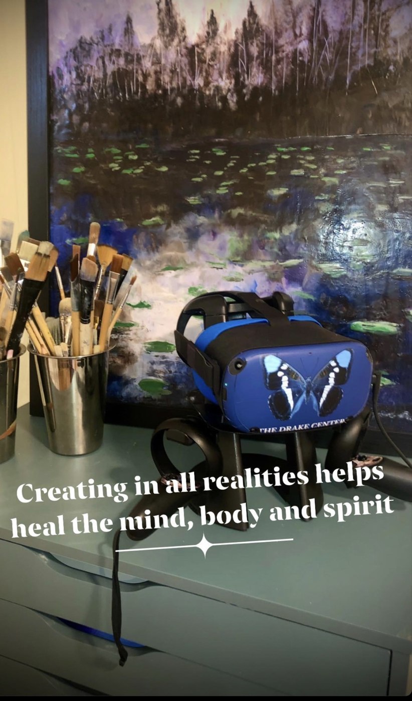 A butterfly-branded VR headset beside painting supplies