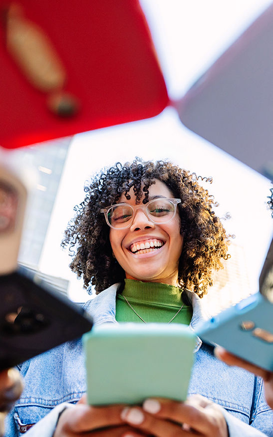 happy-young-woman-using-mobile-phones-standing-wit-2025-03-11-00-12-22-utc.jpg