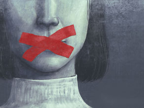 Close-up of a pale face with red tape over the mouth, dark hair, and a gray moody background, suggesting silence or censorship.