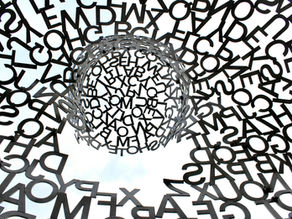 An abstract image of a swirl of random black letters.