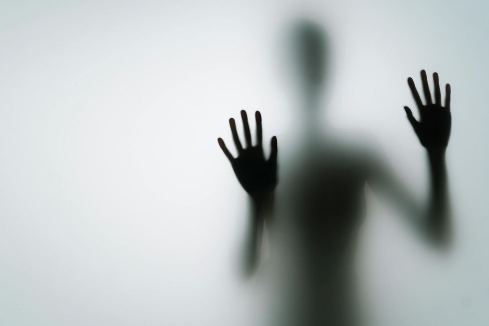 An image of a body placing two hands on a frosted wall of glass. The body remains blurred while the hands appear pressed against the glass.