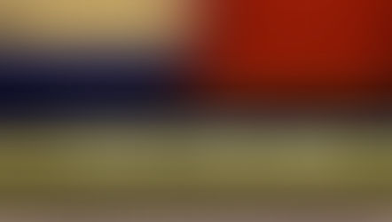 Image showing the 'mind the gap' sign between the yellow line and the edge of the platform. Behind is a blurred train.