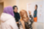 Source: Elly - Photo of women attending week 5 of the programme and interacting with learning materials and community researcher - Ruksana Begum.