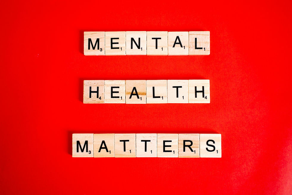 Scrabble tiles spelling Mental Health Matters on a bright red background.