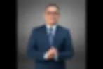 man wearing eyeglasses while holding his hands