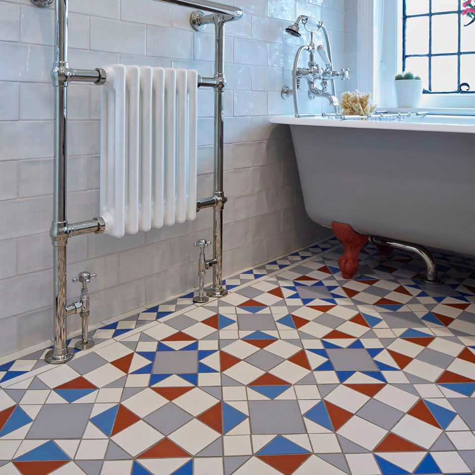 Bathroom with victorian Tiles, cast iron radiator and a freestanding bathtub