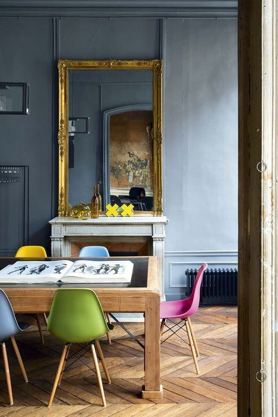 Fred Meylan home in Paris with vintage Eames chairs in many colours and gilded mirror