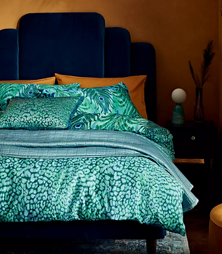 bedding set with two pillows and a comforter against a white background.