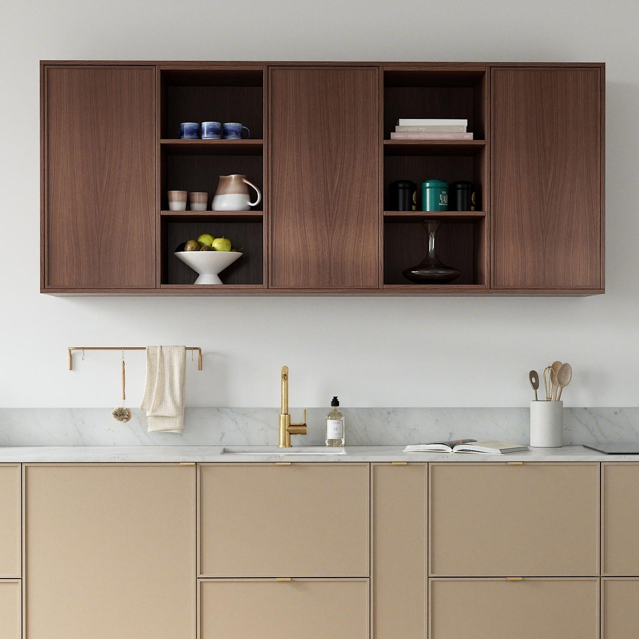 IKEA HACK PLUM LIVING Modern kitchen with wooden countertop, open book, flowers by a gold faucet. Green cabinets, cutting boards, and wall lights enhance decor.