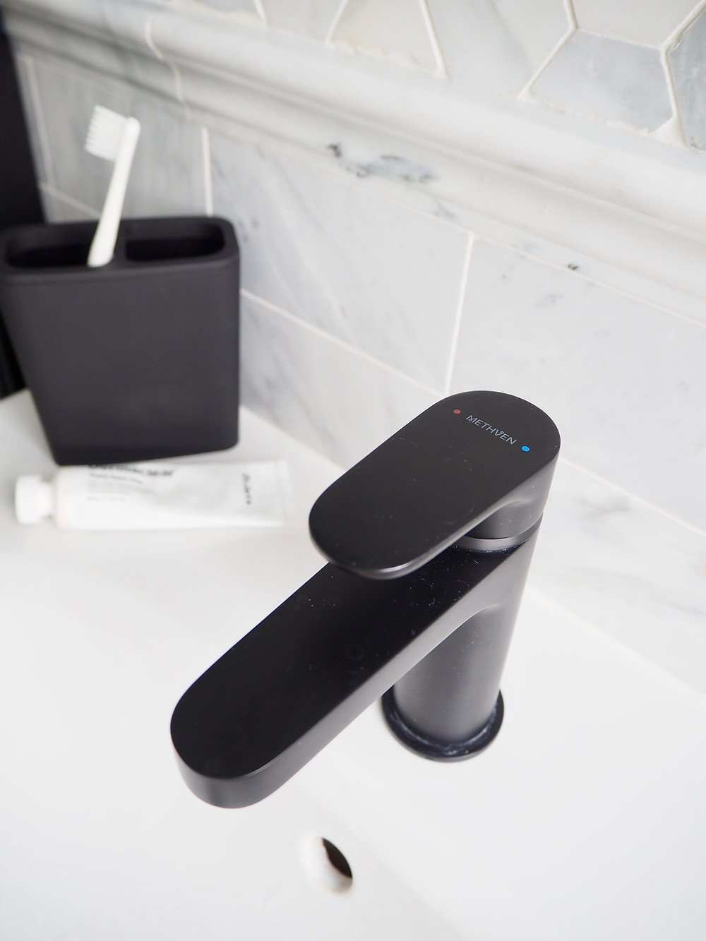 Methven Breeze Matt Black washbasin mixer tap and marble hexagon tiles from Mandarin Stone, VitrA Frame sink vanity