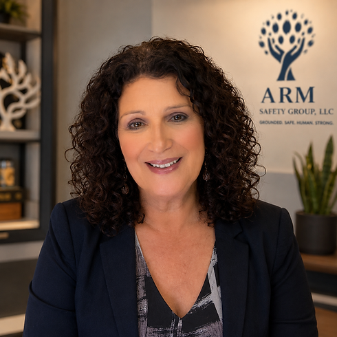 Smiling woman with dark curly hair in front of ARM Safety Group logo
