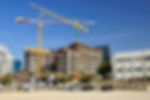 Construction site with two yellow cranes and building frame