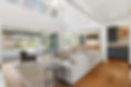 living room with hard wood floors and accordian patio doors.jpg