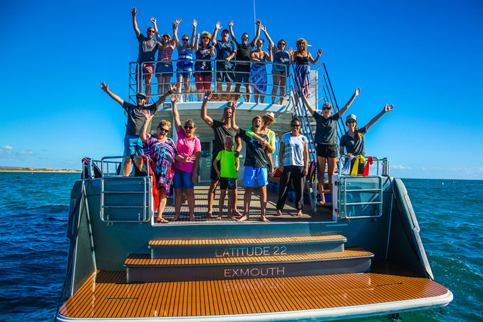 people cheering on the back of the boat after amazing day out on the water