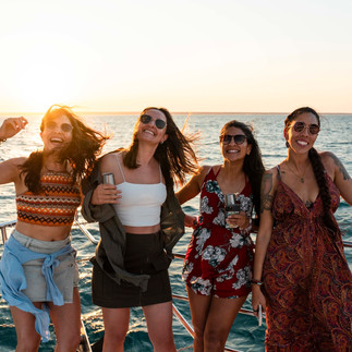guests getting photos taken on tour with sunset behind them